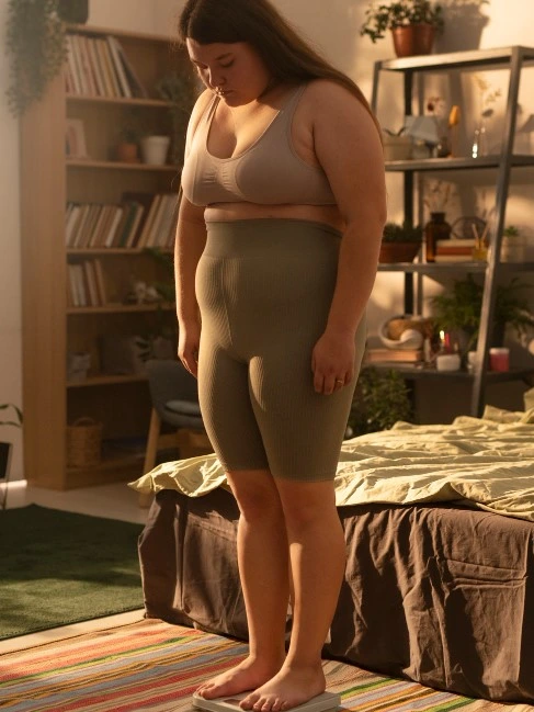 Woman looking at her body